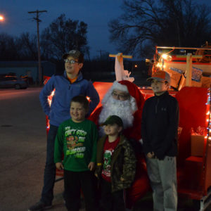 Santa handing out gifts to County Kids