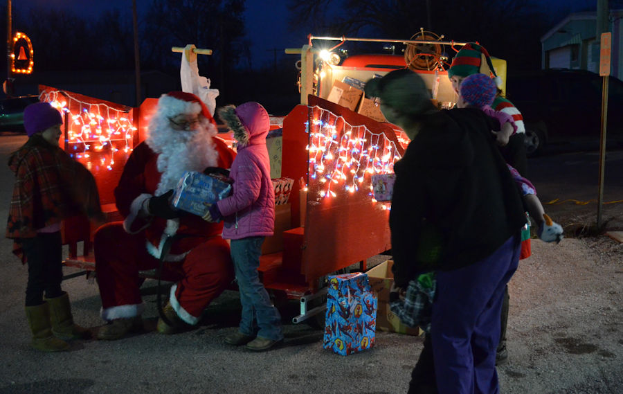 Santa handing out gifts to County Kids